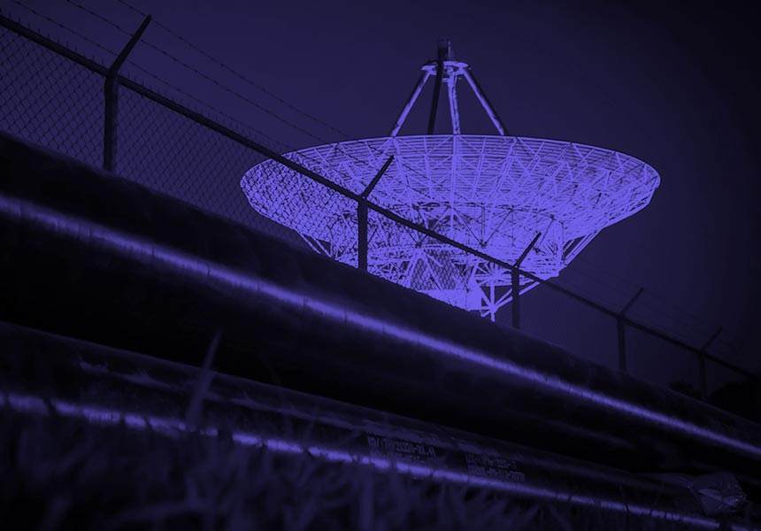 Image of a a large satellite dish in a secure location.